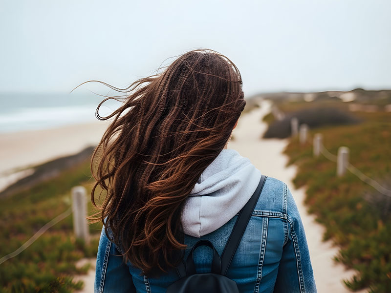 Quliaty Minds Program - young female walking along the beach